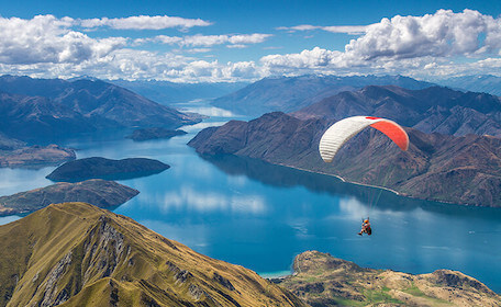 buck skydiving over auckland river and mountains