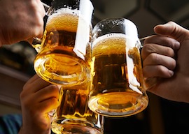 Hands of three men toasting with beer