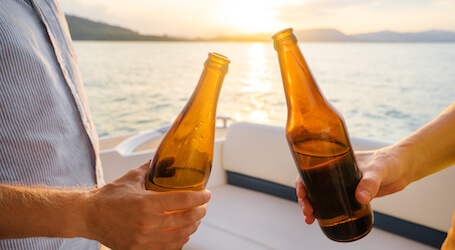 two bucks cheers beers on back of boat charter