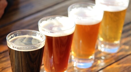 four craft beers on a table at the brewery