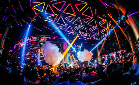 crowd partying nightclub with lights and smoke