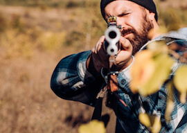 buck holding clay target shotgun ready to shoot