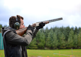 buck aiming at targets with clay shotgun