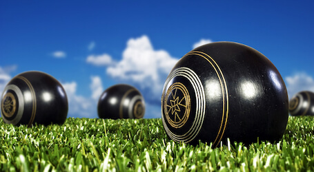 three lawn bowls on the green