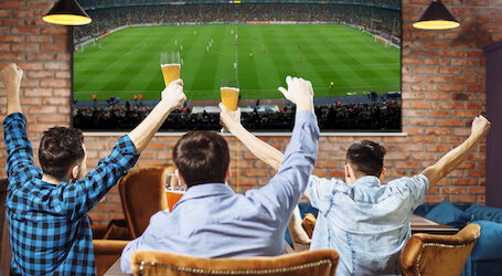 group of bucks watching the tv at a sports bar