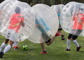 group of bucks playing bubble soccer