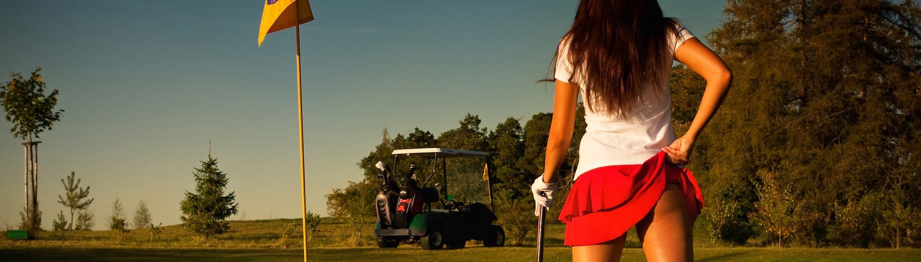 cheeky golf bunny holding up red skirt showing bum