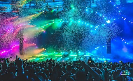 crowd partying at nightclub with lights and confetti