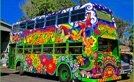large rainbow print double decker bus in Byron bay