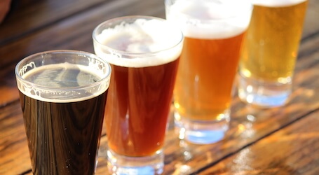 four beer glasses on a table