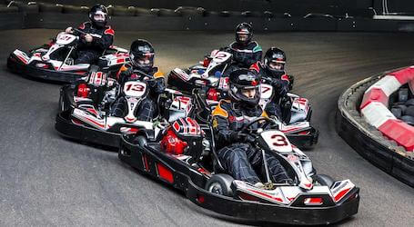 group of bucks in go karts racing around the track