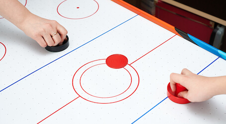 bucks group on the air hockey table