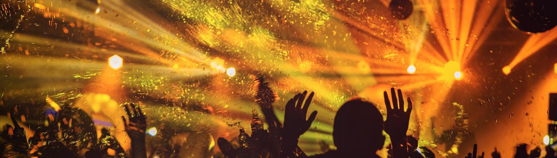 crowd dancing in nightclub with flashing lights