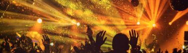 crowd dancing in nightclub with flashing lights