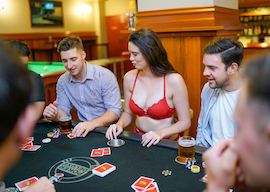 group of bucks at poker table with lingerie waitress