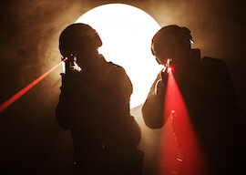 two bucks playing laser skirmish pointing laser guns