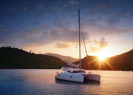 luxury yacht in the harbour with sunset in the background