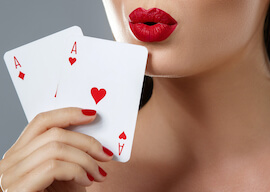 waitress with red lipstick holding pair of aces