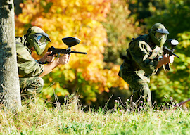 two bucks on the paintball field ready to shoot