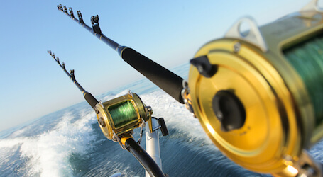 two deep sea fishing rods off back of boat