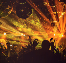 crowd dancing in nightclub with flashing lights