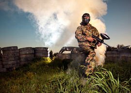 buck on paintball field with smoke in the background