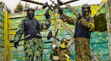 three bucks posing after victory on the paintball field