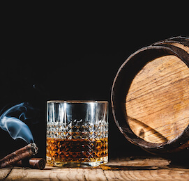 buck drinking glass of rum and smoking cigar