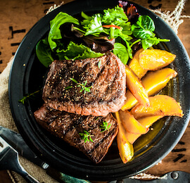 steak and chips on table