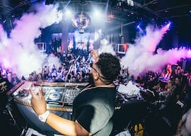 dj in surfers paradise nightclub with crowd dancing and smoke machine