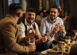 three lads having a group bucks dinner