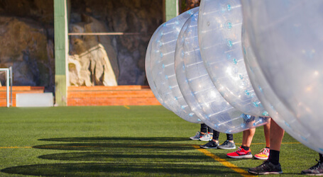 group of bucks playing bubble soccer