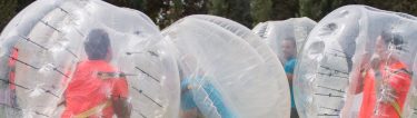 group of bucks playing bubble soccer