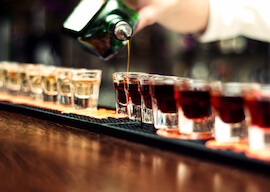 bartender pouring shots at bar