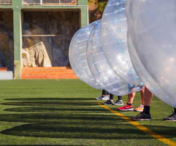 group of bucks playing bubble soccer