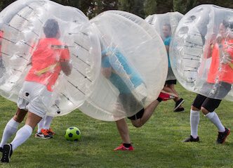 group of bucks playing bubble soccer