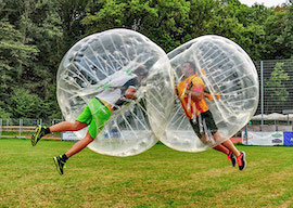 group of bucks playing bubble soccer