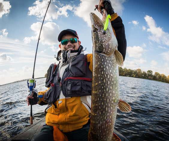 buck catching large fish on fishing trip