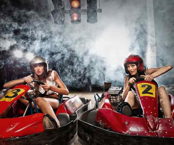 two beautiful waitresses racing go karts