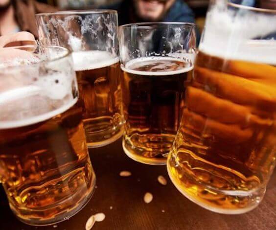 group of bucks cheering four beer glasses