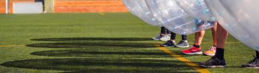 group of bucks playing bubble soccer