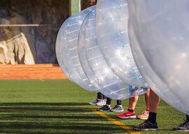 group of bucks playing bubble soccer