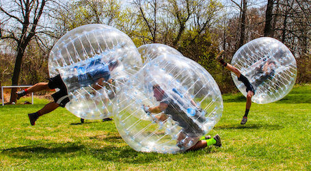 group of bucks playing bubble soccer