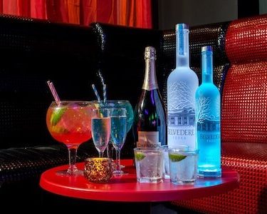 VIP booth in club with spirits and cocktails