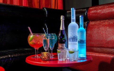 VIP booth in club with spirits and cocktails