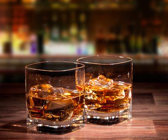 two glasses of whiskey on bar