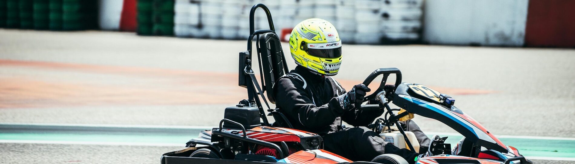 man is racing a go kart through the course