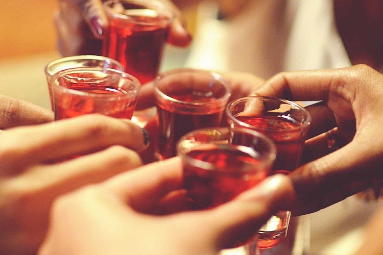 friends cheering shot glasses