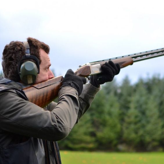 man ready to shoot clay targets with gun