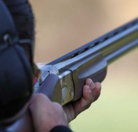 man shooting clay targets with gun